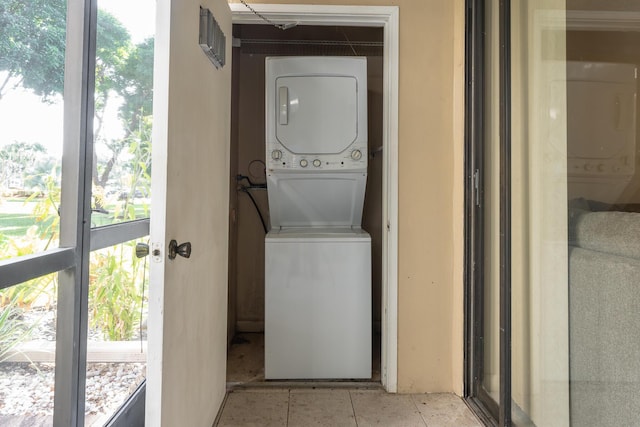 laundry room with stacked washing maching and dryer