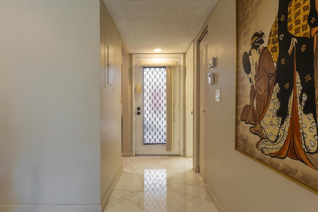 corridor featuring a textured ceiling