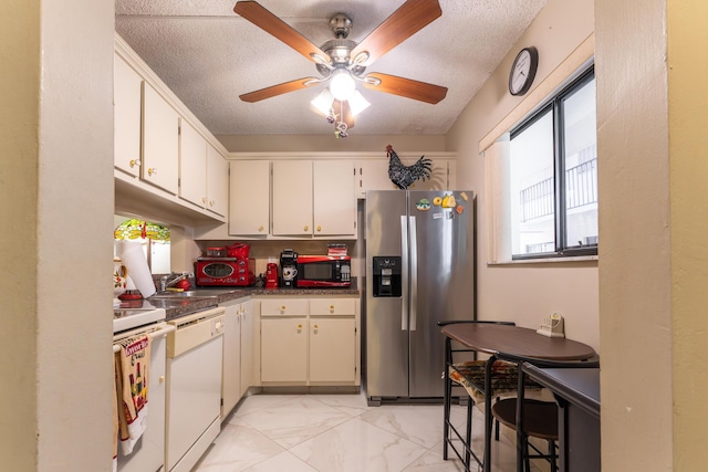 kitchen featuring a textured ceiling, white appliances, ceiling fan, sink, and white cabinetry