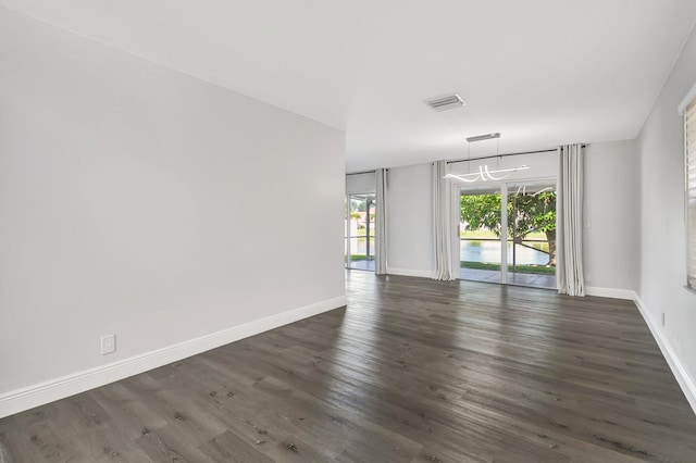 empty room with dark wood-type flooring