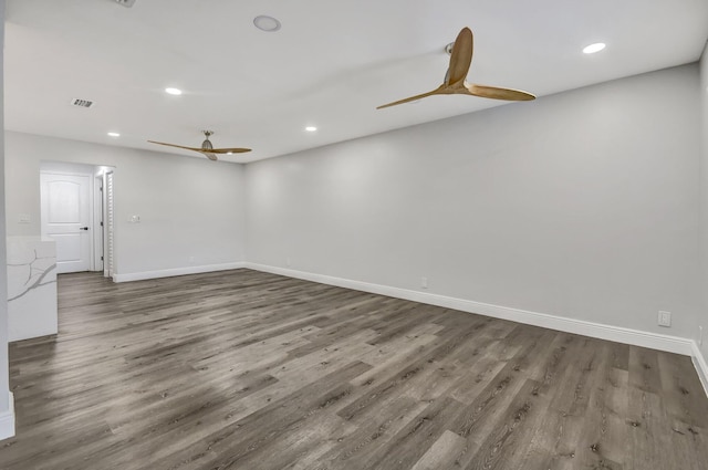 spare room with ceiling fan and wood-type flooring