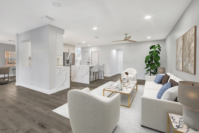 living room with ceiling fan and dark hardwood / wood-style floors