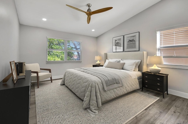 bedroom featuring ceiling fan, vaulted ceiling, and wood-type flooring