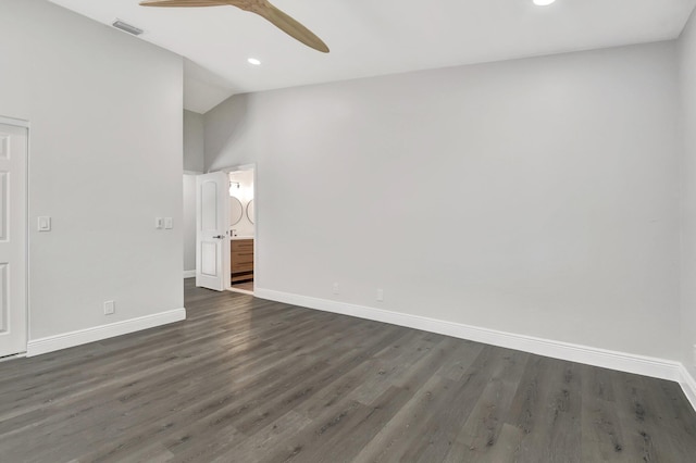 spare room featuring ceiling fan, dark wood-type flooring, and vaulted ceiling