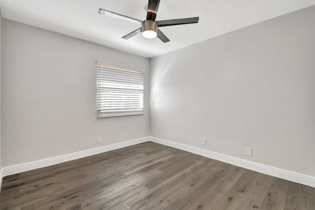 empty room with dark hardwood / wood-style flooring and ceiling fan