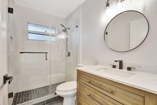 bathroom with toilet, an enclosed shower, tile patterned floors, and vanity