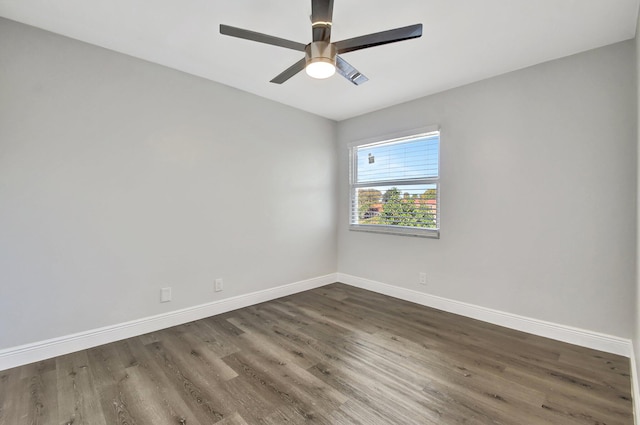 spare room with dark wood-type flooring and ceiling fan