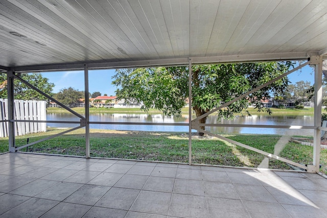 unfurnished sunroom featuring a wealth of natural light and a water view