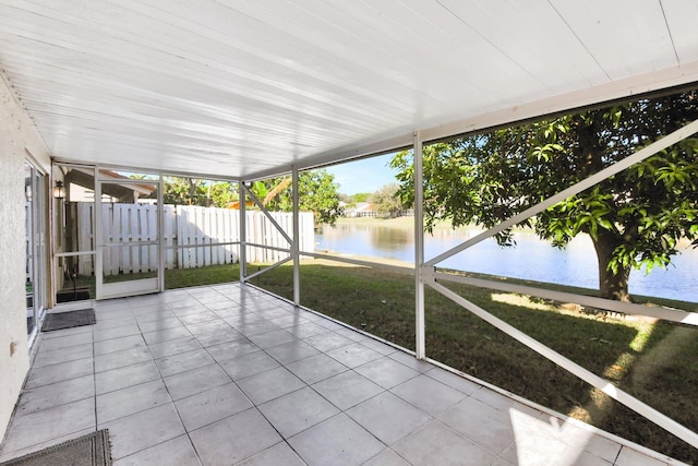 unfurnished sunroom with a water view