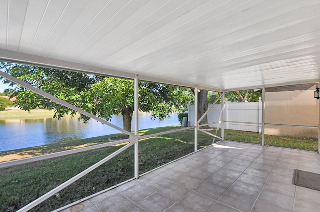 unfurnished sunroom featuring plenty of natural light and a water view