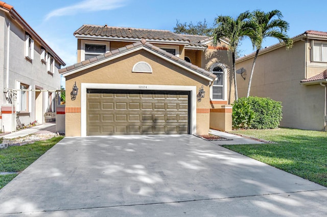 view of front of property featuring a front lawn and a garage