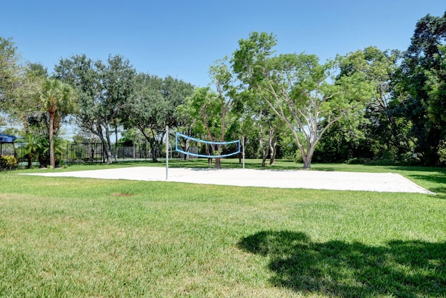 view of community featuring volleyball court and a yard