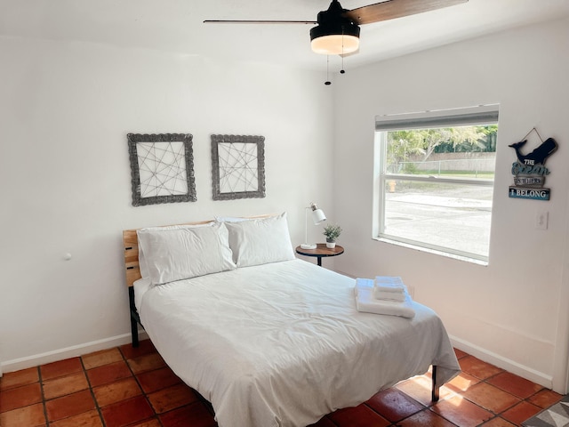 bedroom featuring ceiling fan and tile patterned flooring