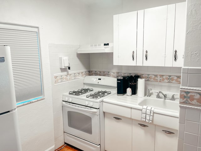 kitchen featuring white cabinetry, sink, white appliances, decorative backsplash, and custom exhaust hood