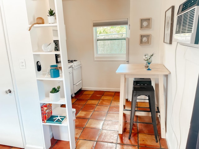 interior space featuring tile patterned floors and an AC wall unit