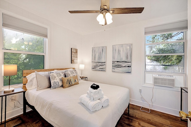 bedroom with multiple windows, ceiling fan, and dark wood-type flooring