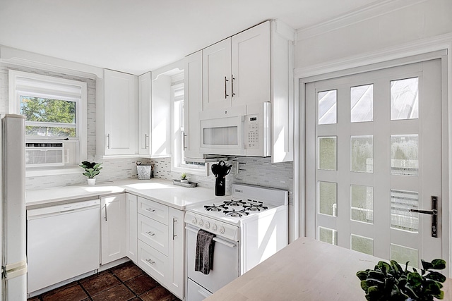 kitchen with white cabinets, white appliances, tasteful backsplash, and cooling unit