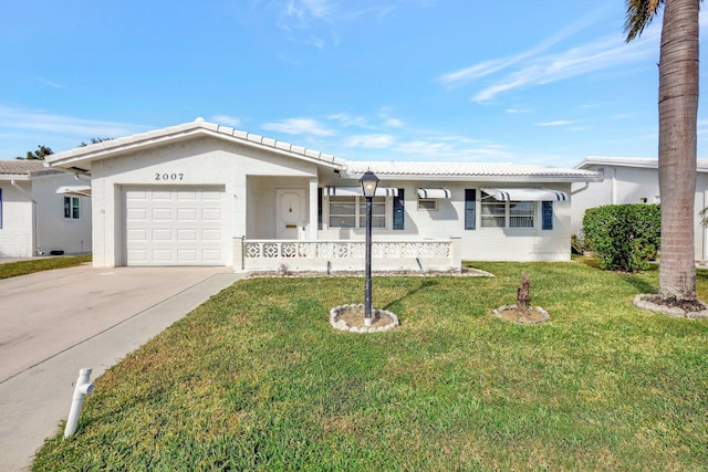 ranch-style home featuring a garage and a front lawn