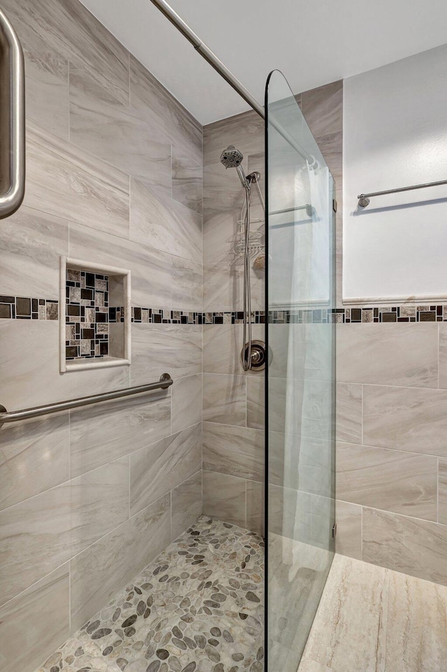 bathroom featuring a shower with door