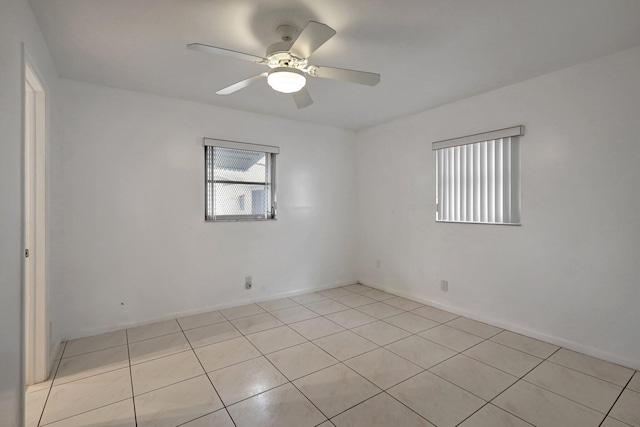 spare room featuring ceiling fan and light tile patterned flooring