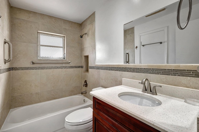 full bathroom featuring backsplash, tiled shower / bath, vanity, and toilet