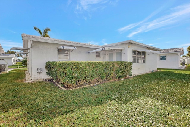 view of side of home featuring a lawn