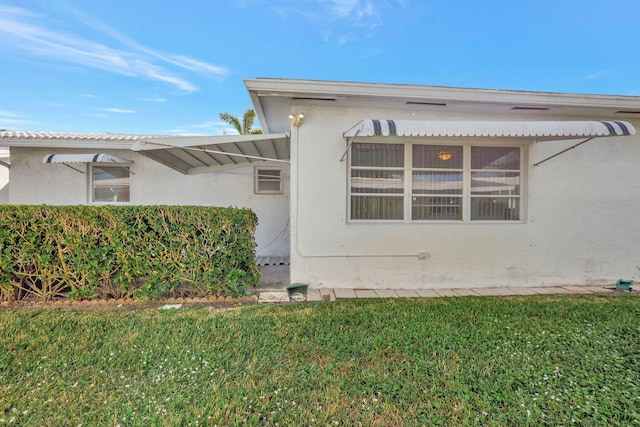 view of side of property with a lawn