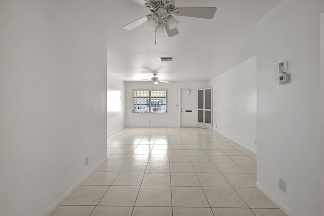 tiled spare room with ceiling fan