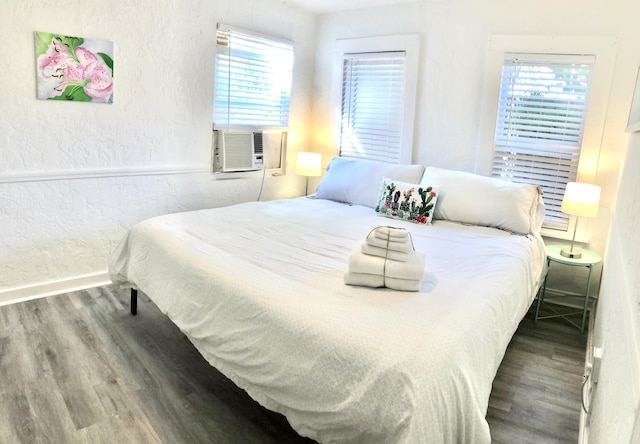 bedroom featuring hardwood / wood-style floors and cooling unit