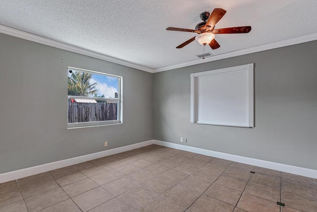 tiled spare room featuring ceiling fan, a textured ceiling, and ornamental molding