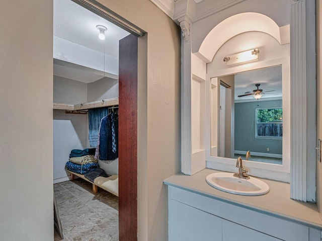 bathroom with ceiling fan, crown molding, and vanity