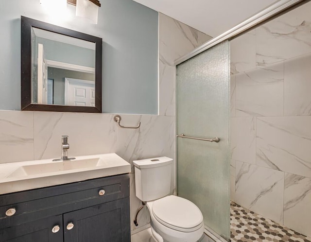 bathroom with toilet, a shower with shower door, tasteful backsplash, tile walls, and vanity