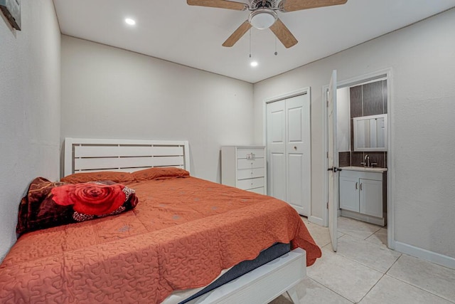 bedroom with ceiling fan, light tile patterned floors, a closet, and sink