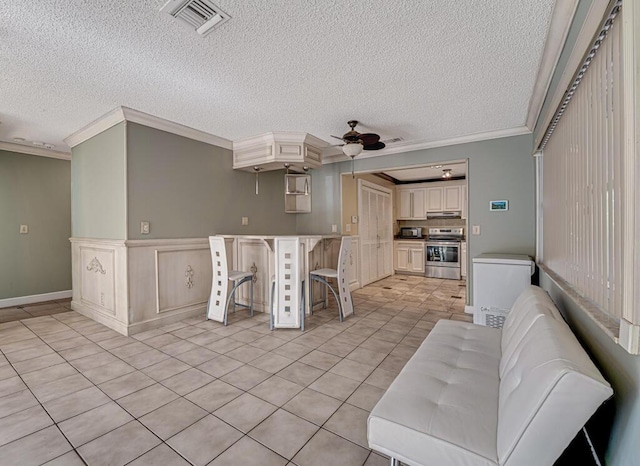 living room with ceiling fan, light tile patterned flooring, and crown molding