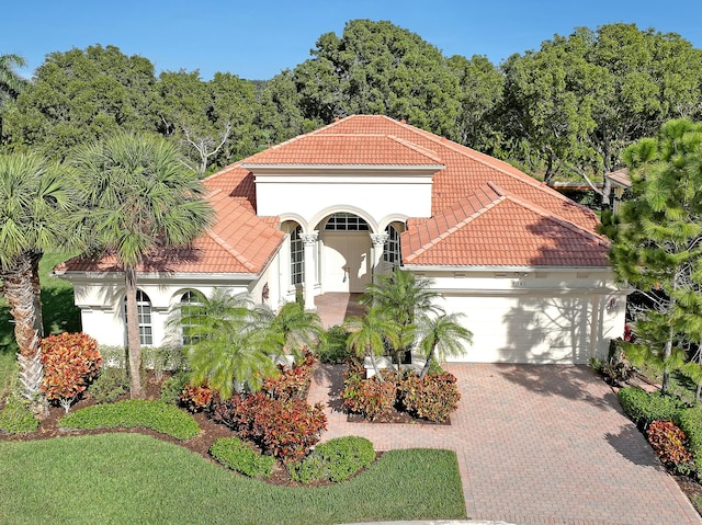 mediterranean / spanish-style home featuring a garage