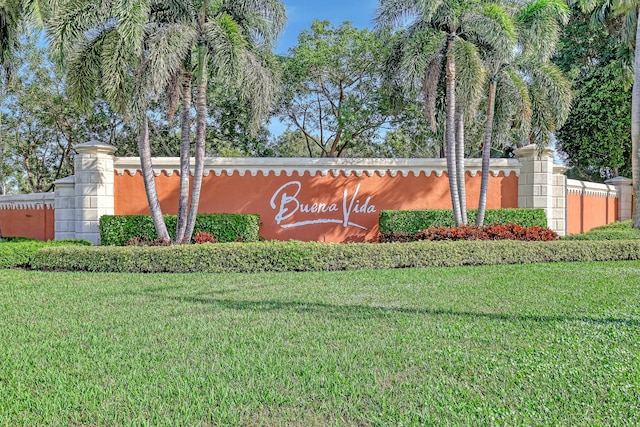 community / neighborhood sign with a lawn