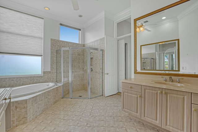 bathroom with plus walk in shower, vanity, a healthy amount of sunlight, and ornamental molding