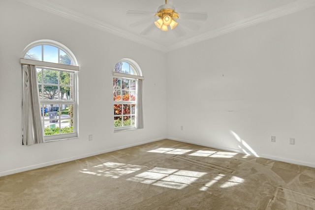 unfurnished room featuring ceiling fan, light colored carpet, and ornamental molding