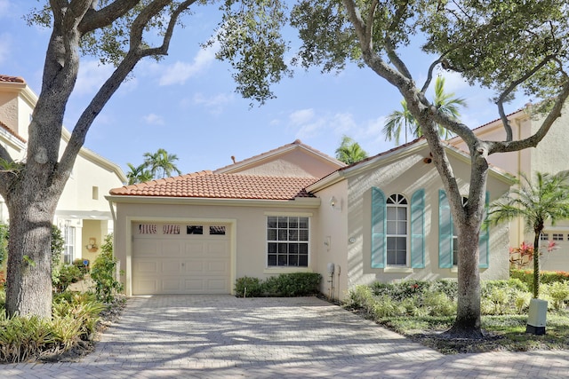 mediterranean / spanish-style home with a garage