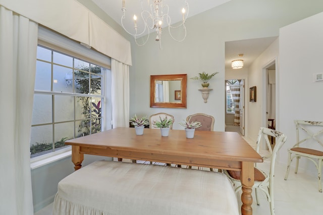 tiled dining space featuring a chandelier