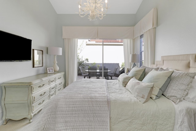 carpeted bedroom with a chandelier, access to exterior, and vaulted ceiling