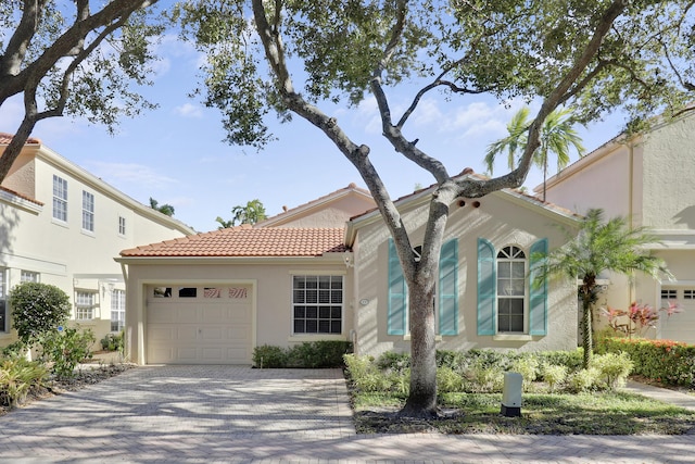 mediterranean / spanish-style home featuring a garage