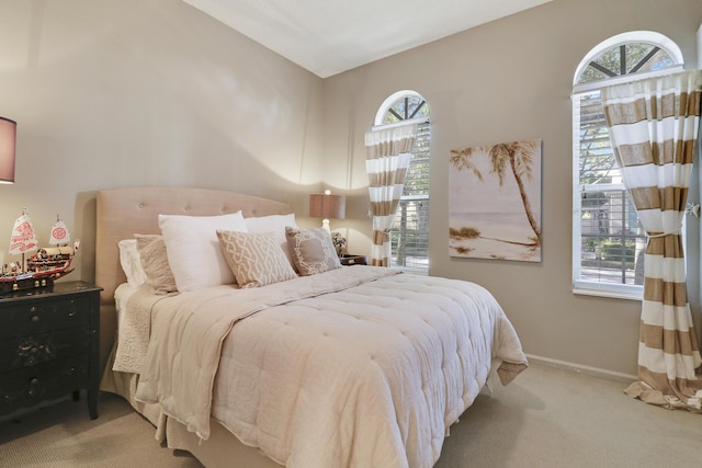 carpeted bedroom featuring multiple windows