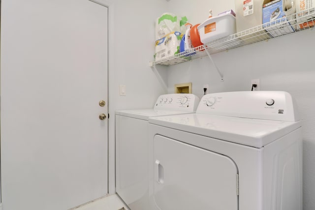 clothes washing area with washer and clothes dryer