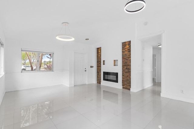 unfurnished living room with light tile patterned floors and vaulted ceiling