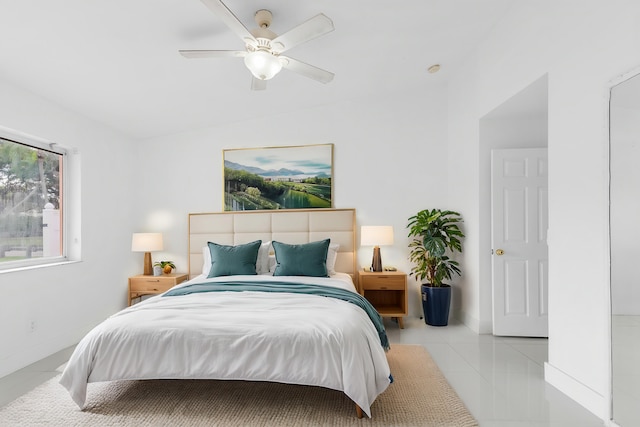 bedroom with ceiling fan and light tile patterned floors