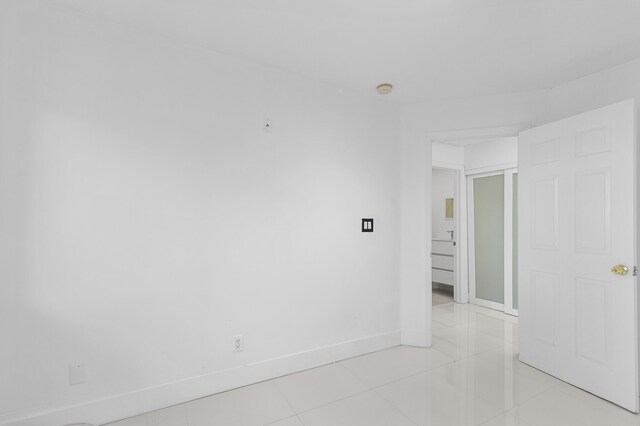 empty room with light tile patterned flooring