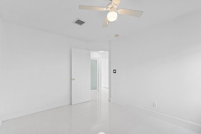 tiled empty room with ceiling fan