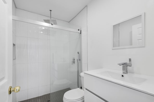 bathroom with toilet, vanity, and an enclosed shower