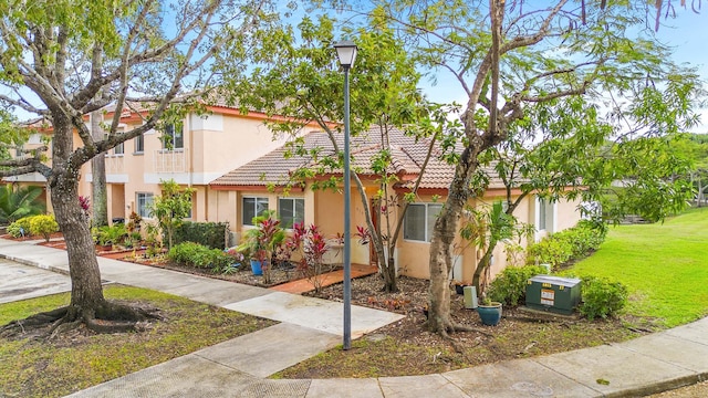 mediterranean / spanish home featuring a front yard